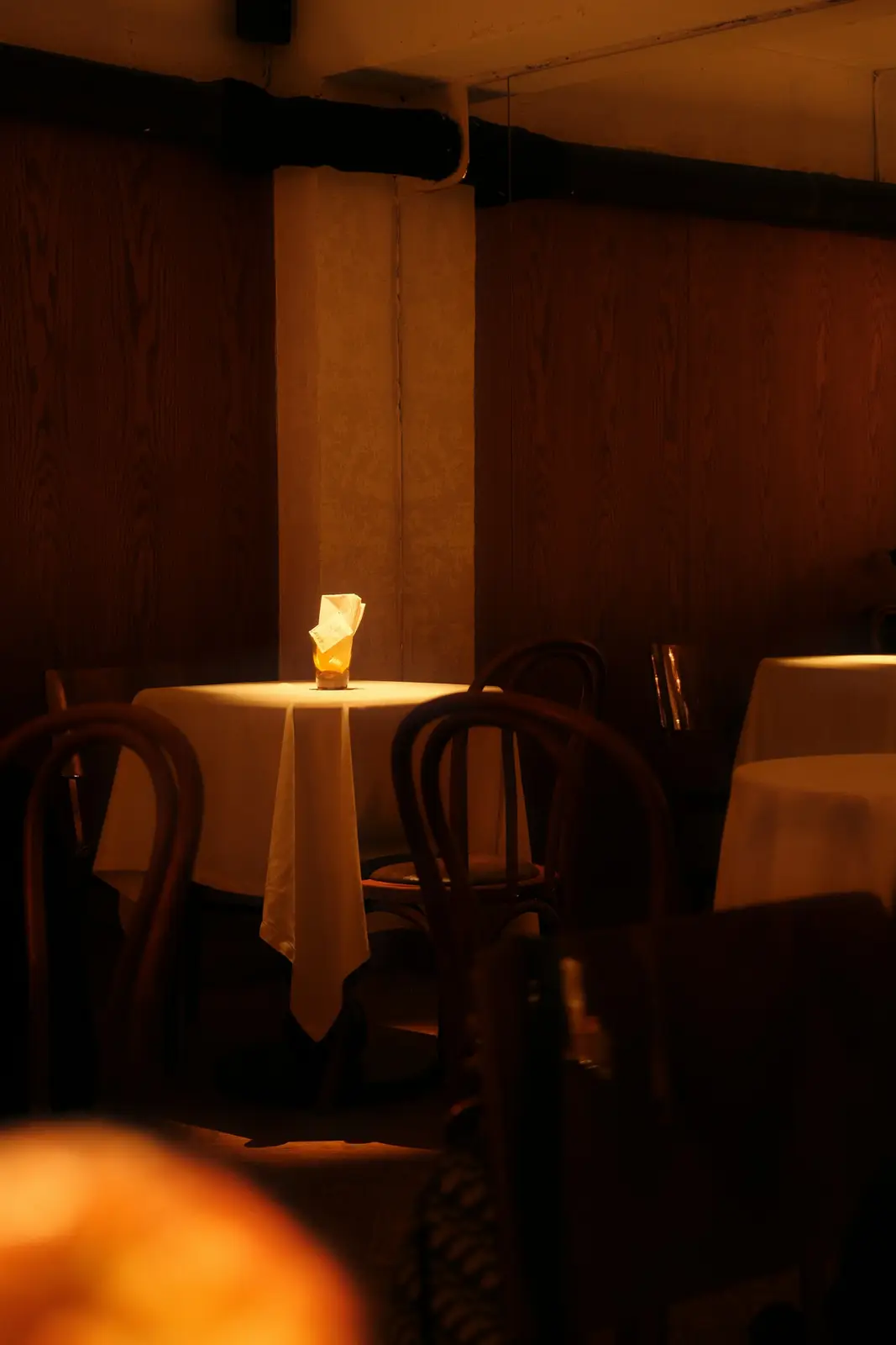 A candle on a dark restaurant table