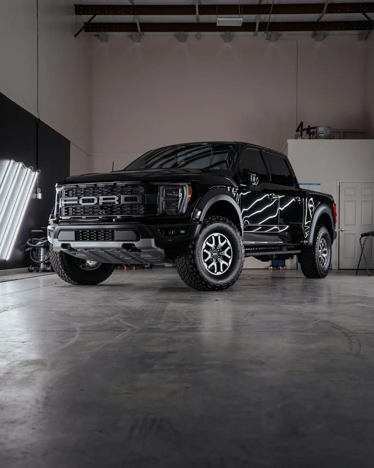 A black pickup truck, freshly detailed, parked in a garage