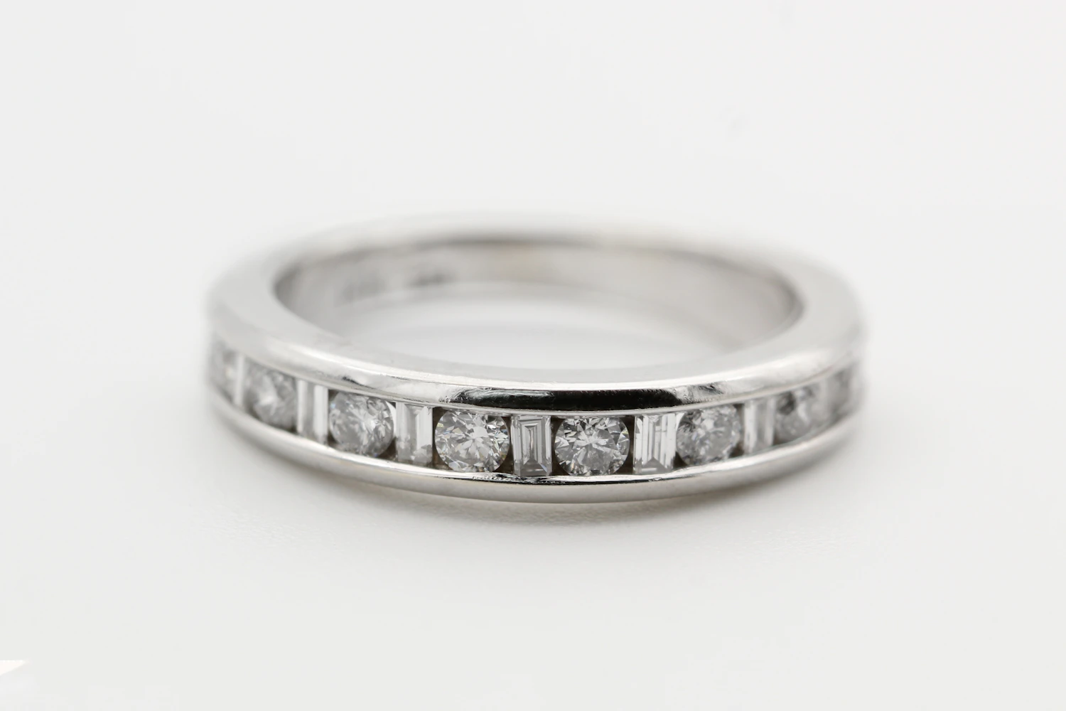 White-gold band with a row of square diamonds set flush in a channel