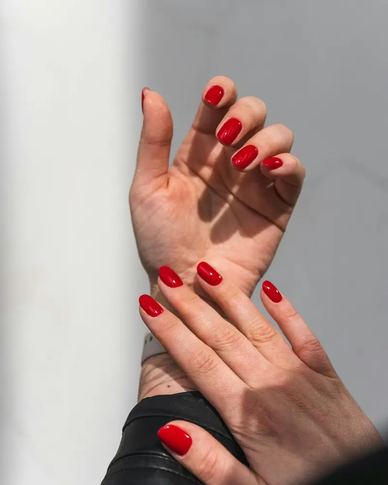 Short almond nails in a glossy classic red