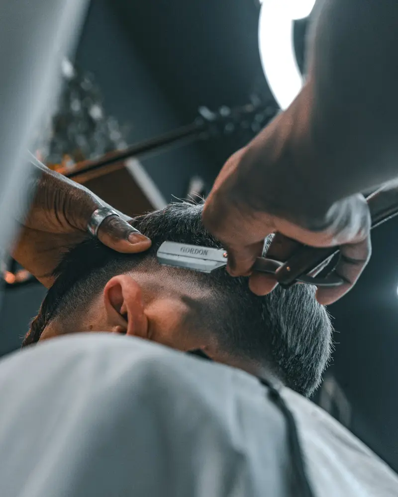 A blade finishing the lowest part of a fade above the ear